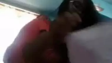 Smiling Indian with glasses listens to music and undresses at once