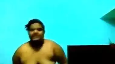 Mature Desi in a red sari exposes her big sex parts in a XXX show