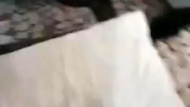 Desi woman lies in bed with legs spread while man touches XXX parts
