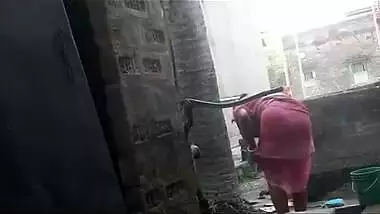 my maid taking shower at backyard