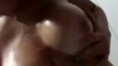 Beautiful girl massaging lovely boobs with lotion